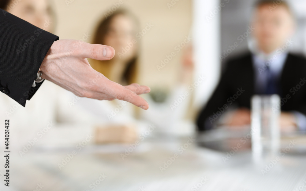 Business presentation. Unknown businessman giving a speech to colleagues or partners at corporate conference. Meeting concept Business presentation. Unknown businessman giving a speech to colleagues or partners at corporate conference. Meeting concept