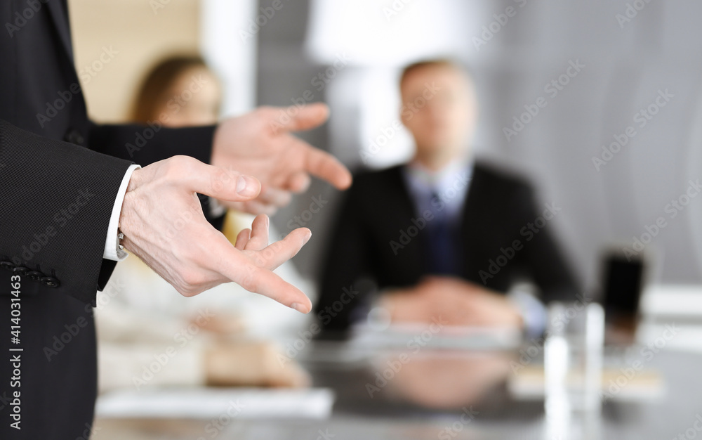 Business presentation. Unknown businessman giving a speech to colleagues or partners at corporate conference. Meeting concept Business presentation. Unknown businessman giving a speech to colleagues or partners at corporate conference. Meeting concept