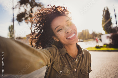 Photo of attractive positive dark skin person take shooting selfie photo toothy smile good mood spending time walking outdoors