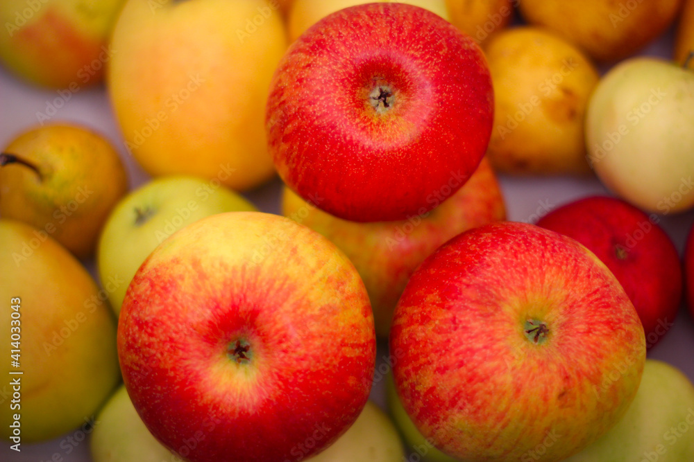 Several red-green apples standing on top of each other Several red-green apples standing on top of each other