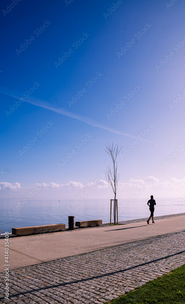 Fototapeta premium Middle aged man running in the waterfront
