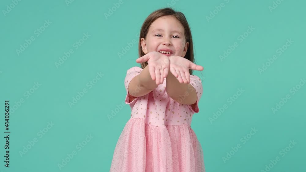 Little toothy smiling cheery cute kid girl 5-6 years old wears pink dress have fun send kiss isolated on pastel blue background child studio portrait. Mother's Day love family people lifestyle concept Little toothy smiling cheery cute kid girl 5-6 years old wears pink dress have fun send kiss isolated on pastel blue background child studio portrait. Mother's Day love family people lifestyle concept