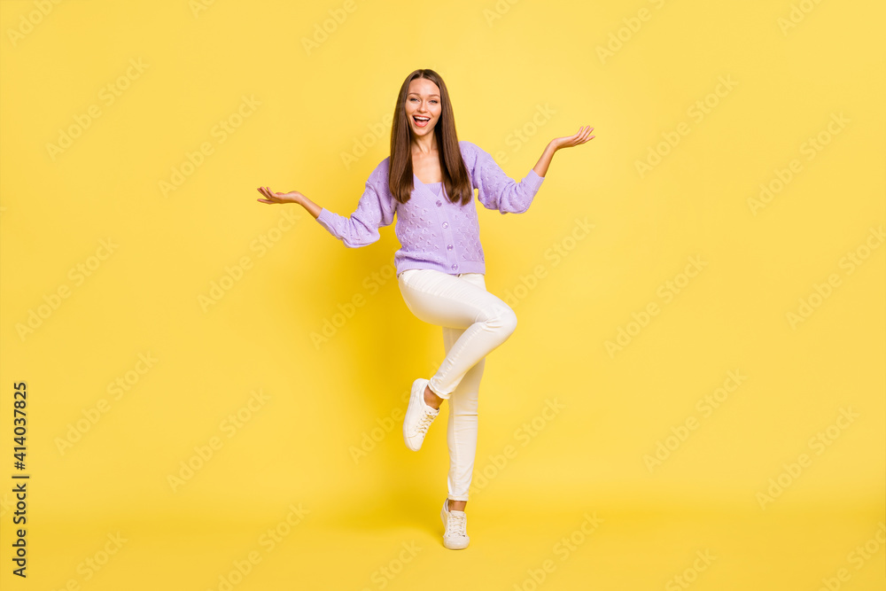 Full length body size view of attractive cheerful girl jumping posing having fun isolated over bright yellow color background Full length body size view of attractive cheerful girl jumping posing having fun isolated over bright yellow color background