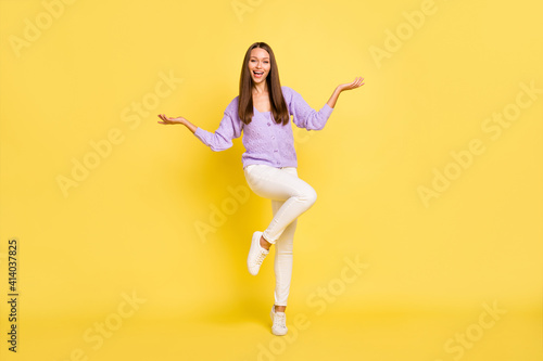 Full length body size view of attractive cheerful girl jumping posing having fun isolated over bright yellow color background