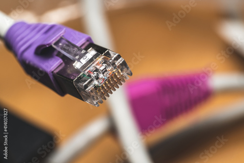 A violet rj45 plug with blurry background, copy-space. photo