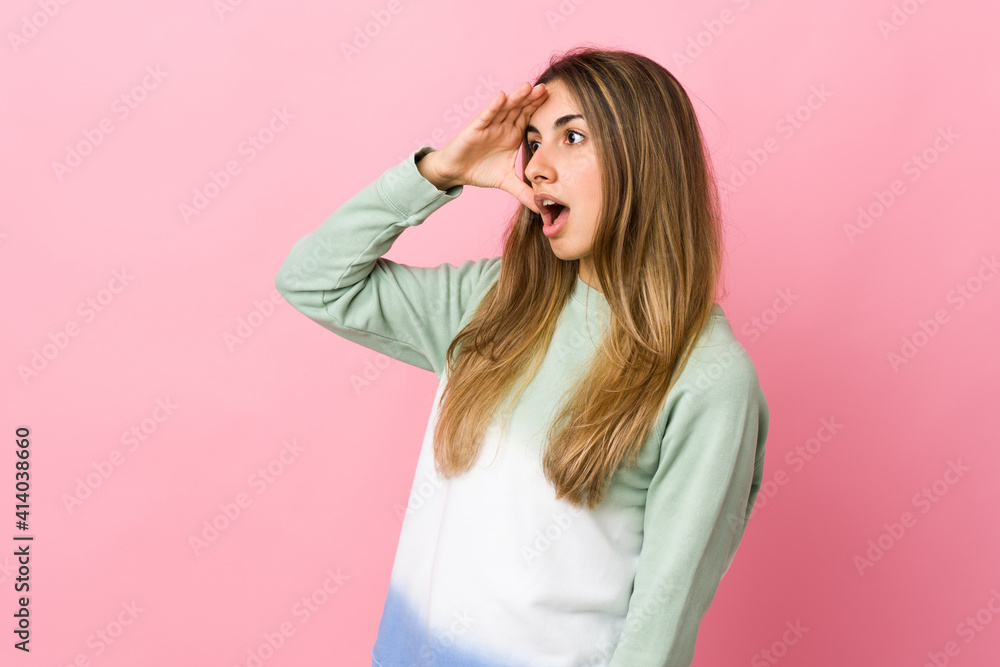 Young woman over isolated pink background with surprise expression while looking side Young woman over isolated pink background with surprise expression while looking side