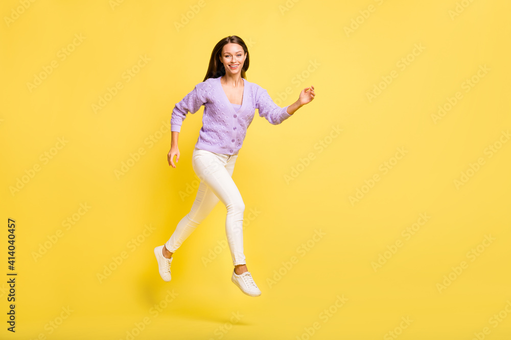 Full length body size view of lovely cheerful slender girl jumping running distance isolated over bright yellow color background