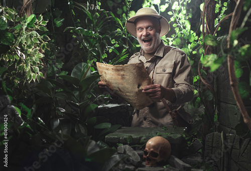 Fotografija Happy adventurer exploring the jungle with a map