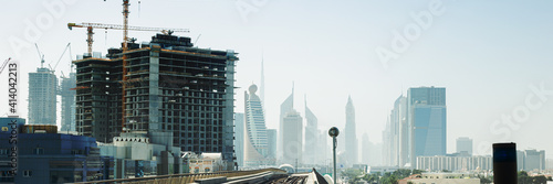 Modern skyscrapers and the construction of new skyscrapers. Dubai, United Arab Emirates. Banner.