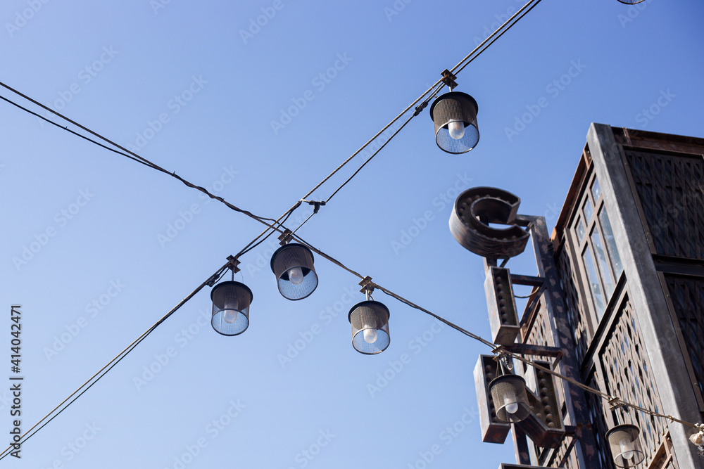 Street lights against the blue sky. City lighting, bottom-up view. Street lights against the blue sky. City lighting, bottom-up view.