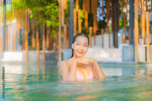 Portrait beautiful young asian woman relax smile enjoy leisure around swimming pool