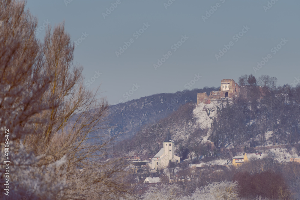 Parish Church and castle ruin of Donaustauf near Regensburg in Bavaria on cold winter day with snow and rime