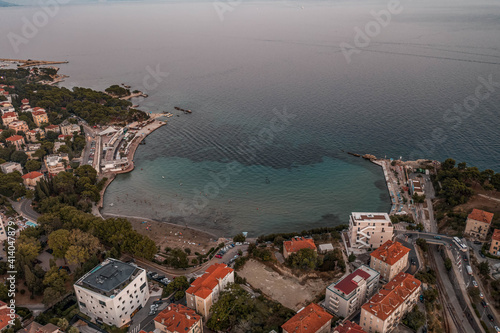 Aerial drone shot of Bacvice city beach near Split old town after sunset in Croatia