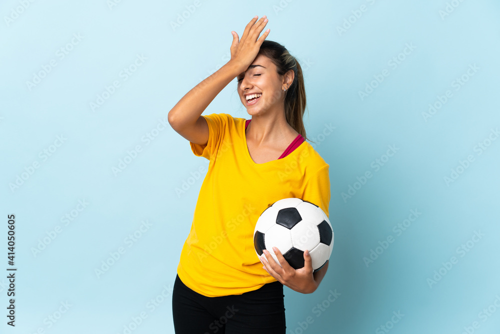 Young hispanic football player woman over isolated on blue background has realized something and intending the solution