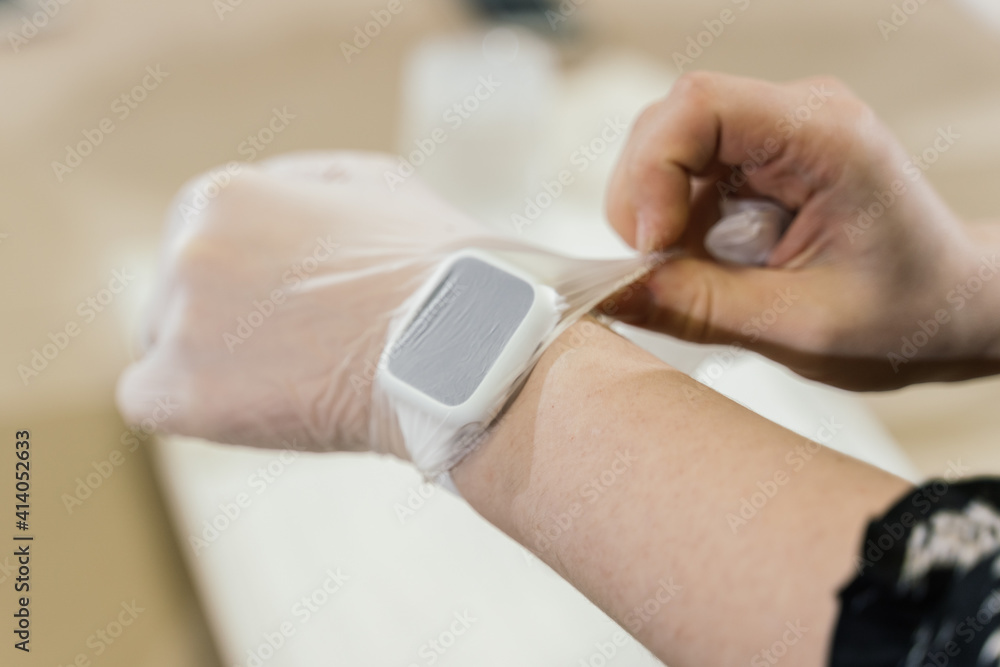 female hands with clock, wearing transparent gloves female hands with clock, wearing transparent gloves