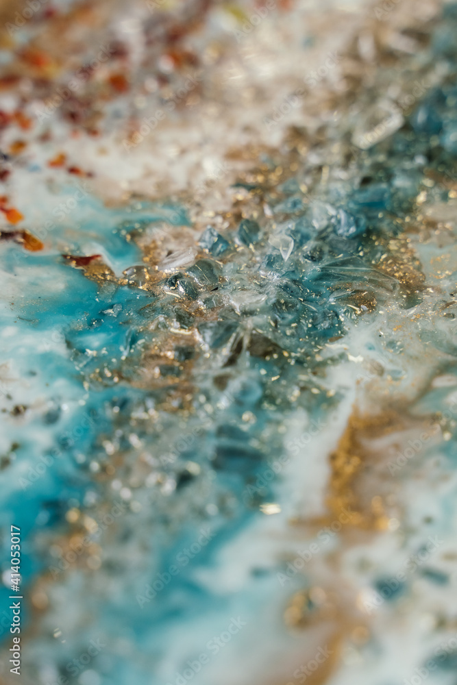 vertical background modern abstract design made with epoxy resin. blotches of amber, gold, transparent and turquoise stones vertical background modern abstract design made with epoxy resin. blotches of amber, gold, transparent and turquoise stones