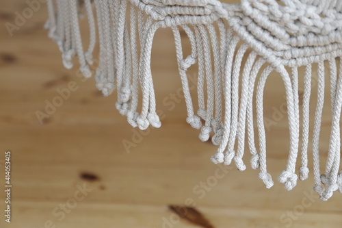 tassels weaving sacrame on a wooden floor background photo