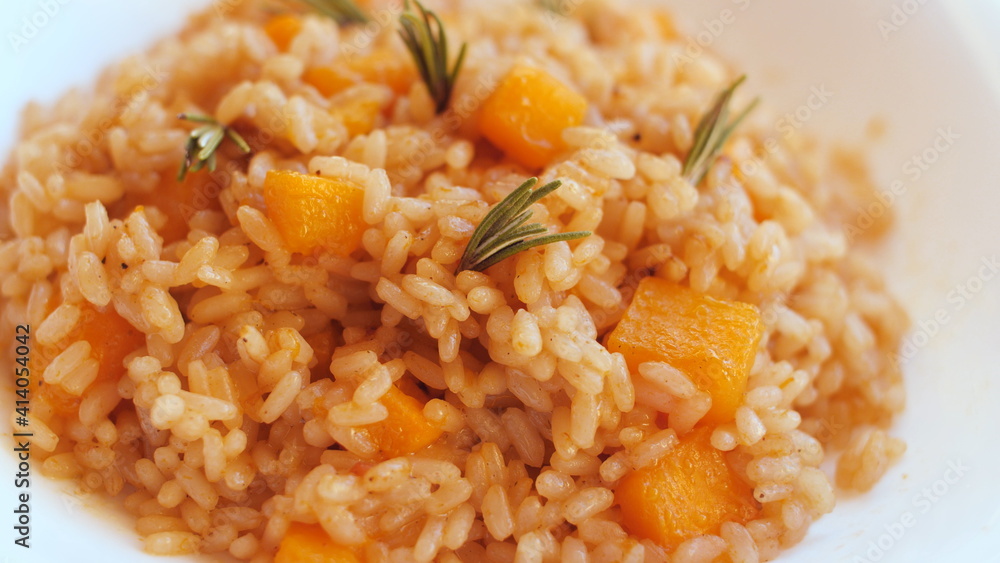 Pumpkin risotto, recipe with rice and pumpkin on rustic table with ingredients. Autumn and Halloween recipe. Pumpkin risotto, recipe with rice and pumpkin on rustic table with ingredients. Autumn and Halloween recipe.