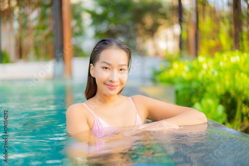 Portrait beautiful young asian woman relax smile enjoy leisure around swimming pool