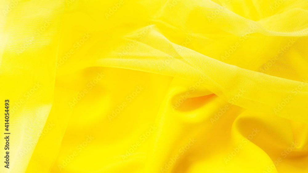 The colors of 2021 are yellow. abstract yellow fabric background. wavy folds, waves of fabric. elegant wallpaper design. texture, pattern. The colors of 2021 are yellow. abstract yellow fabric background. wavy folds, waves of fabric. elegant wallpaper design. texture, pattern.