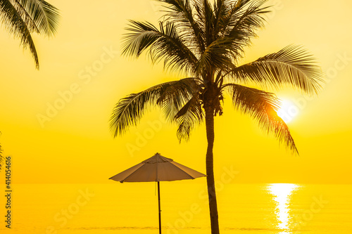 Umbrella and deck chair around beach sea ocean with coconut palm tree