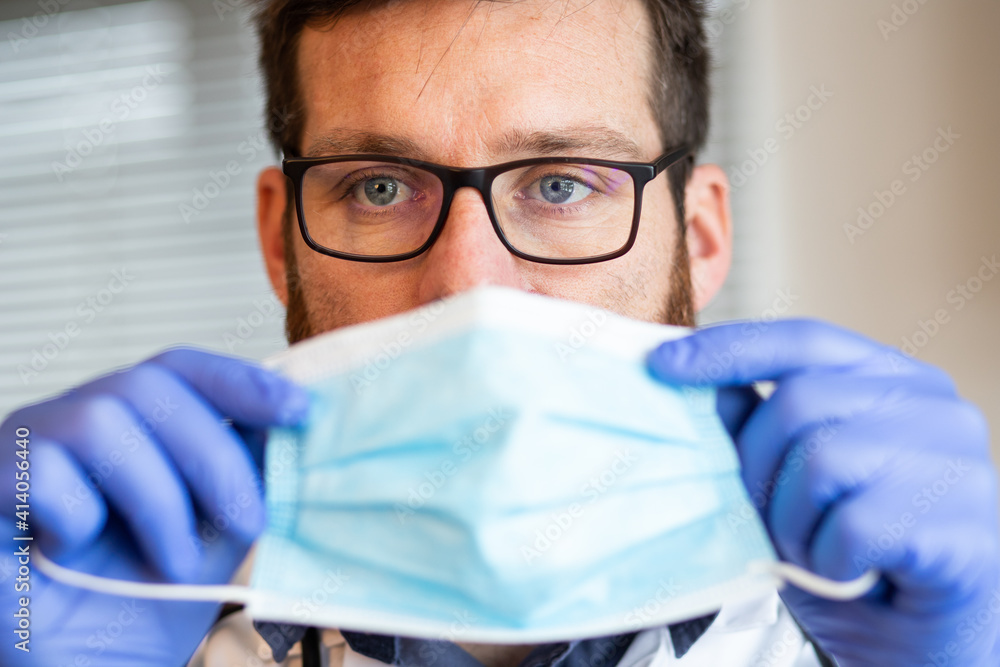 doctor putting on medical mask doctor putting on medical mask