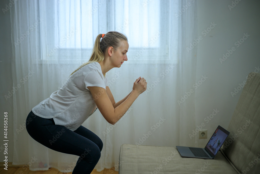 Fototapeta premium Woman making fitness with online instructor