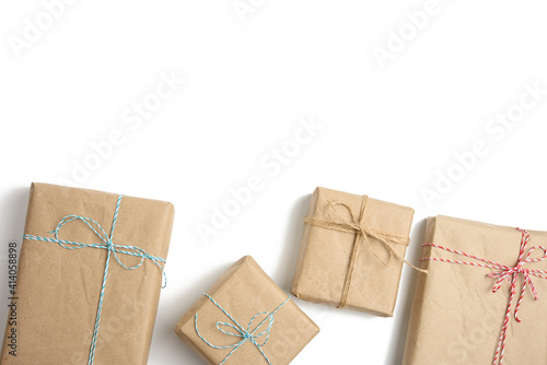box wrapped in brown kraft paper and tied with rope, gift on white background