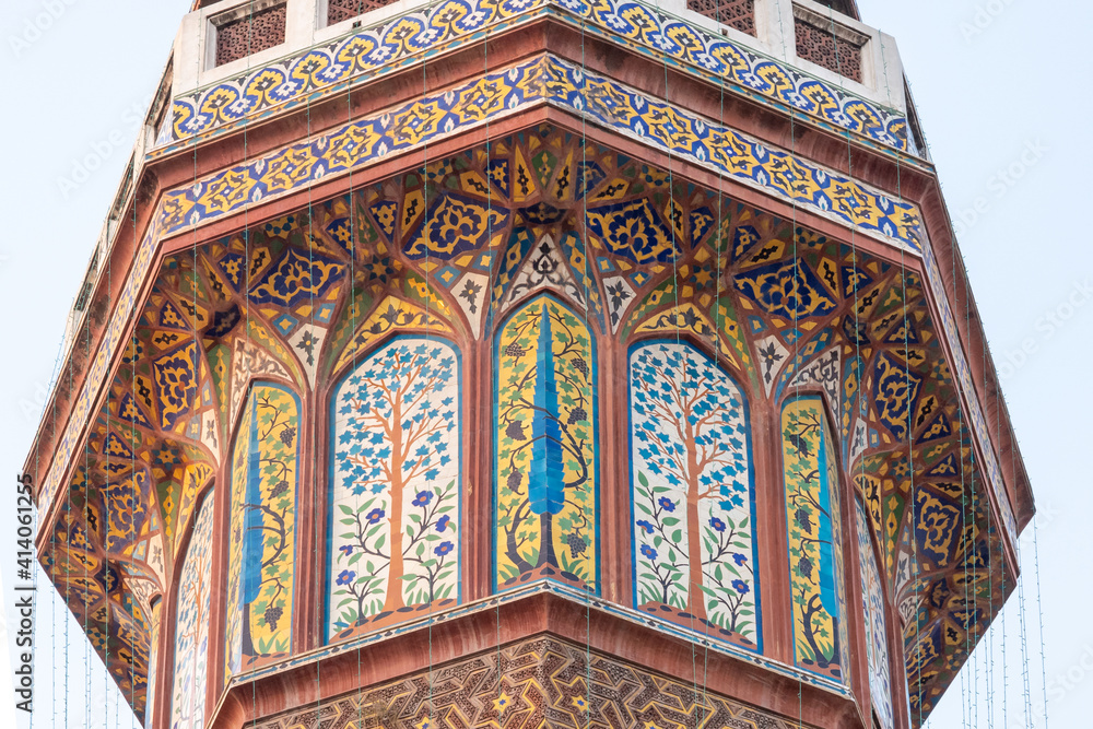 Detail of colorful kashi-kari or faience mosaic decoration on minaret of mughal era Wazir Khan mosque in the walled city of Lahore, Punjab, Pakistan