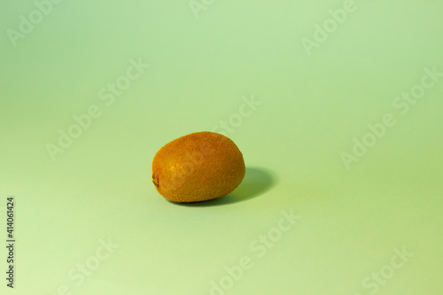 Kiwi on a birch bed background with trendy sunlight.