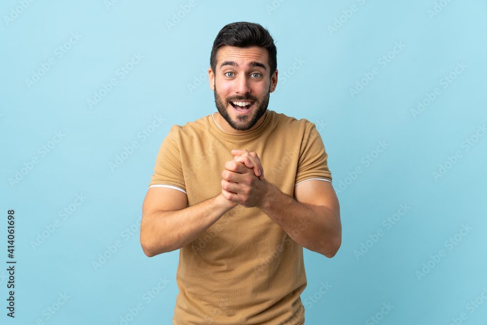 Young handsome man with beard over isolated background laughing Young handsome man with beard over isolated background laughing