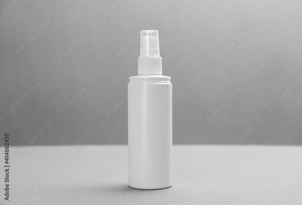 Bottle with insect repellent spray on grey background Bottle with insect repellent spray on grey background