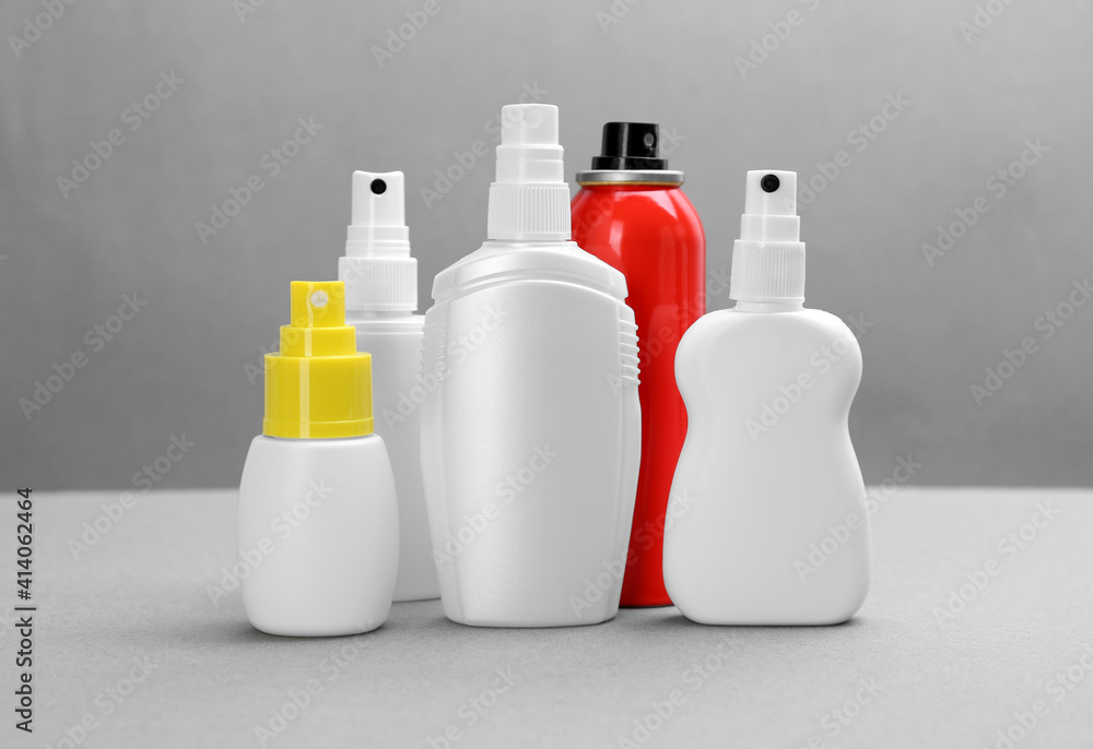 Set of different insect repellents on grey background Set of different insect repellents on grey background