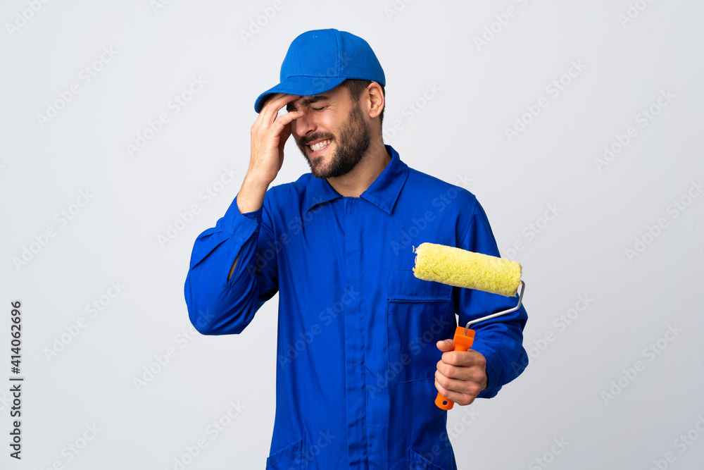 Painter man holding a paint roller isolated on white background laughing