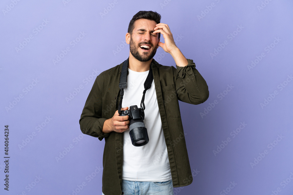 Photographer man over isolated purple background laughing Photographer man over isolated purple background laughing