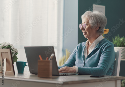Senior lady using a laptop at home