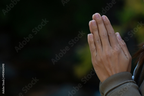  Praying hands with faith in religion and belief in God on dark background. Pay respect. Namaste or Namaskar hands gesture.