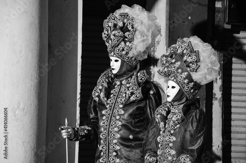 Noble couple masks at St Mark's Square during traditional Carnival. Venice, Italy. Black white historic photo © Elena Dijour