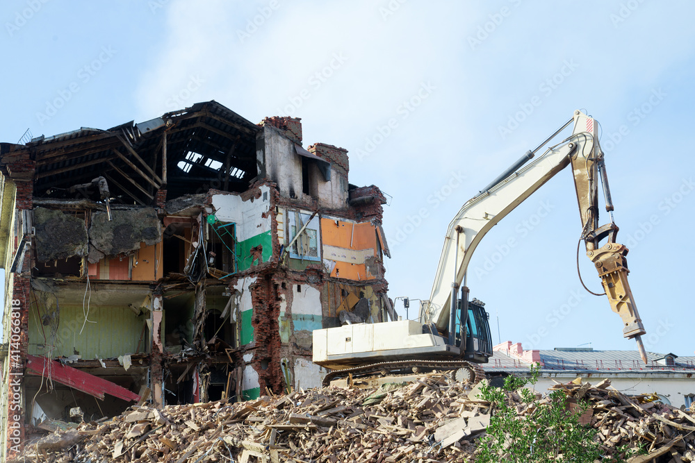 excavator demolishing a brick building. Machinery Demolishing Building excavator demolishing a brick building. Machinery Demolishing Building