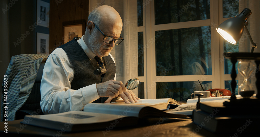 © StockPhotoPro - Senior academic researcher working in his office