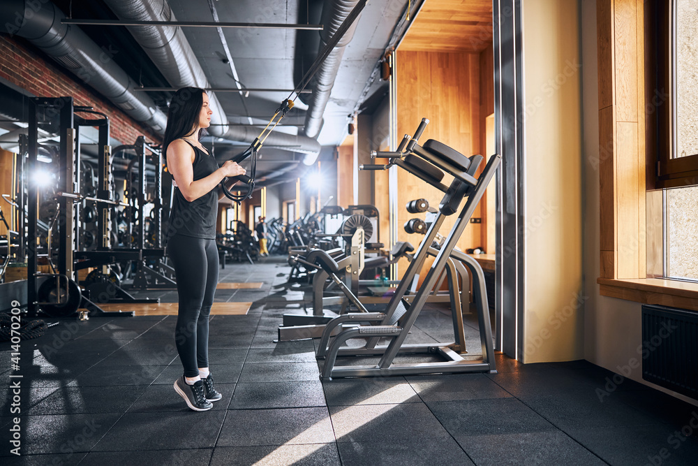 Obraz premium Beautiful slender female visiting gym for workout