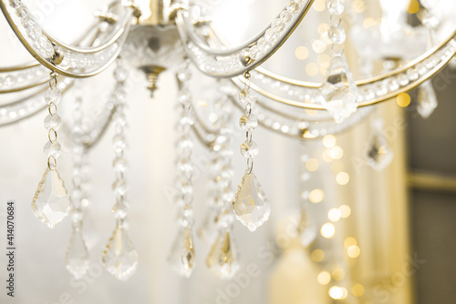 Crystal chandelier close-up. beige light. Selective focus.
