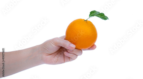 A woman's hand holds a ripe...
