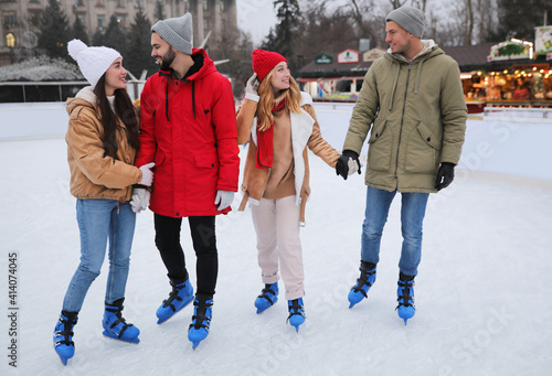Group of friends at outdoor ice skating rink