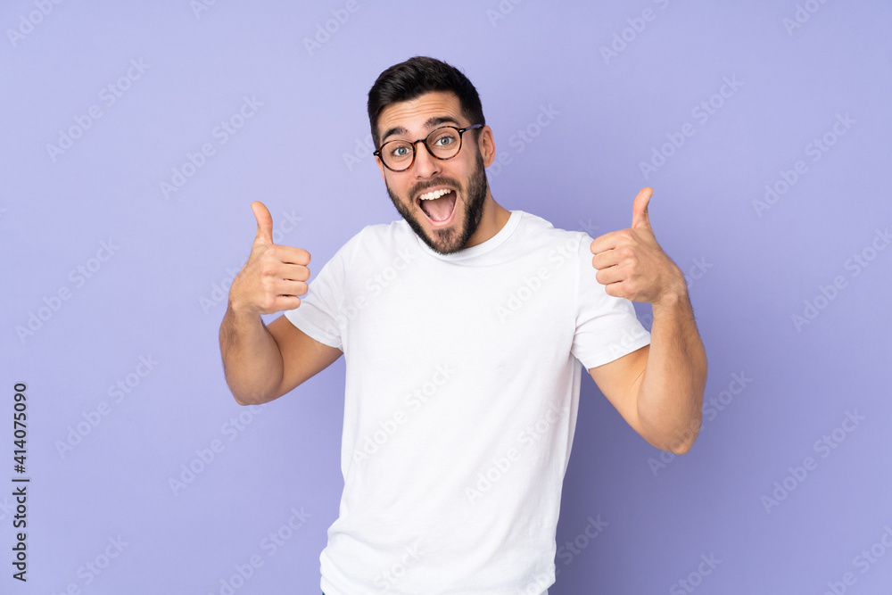 Caucasian handsome man over isolated background giving a thumbs up gesture Caucasian handsome man over isolated background giving a thumbs up gesture