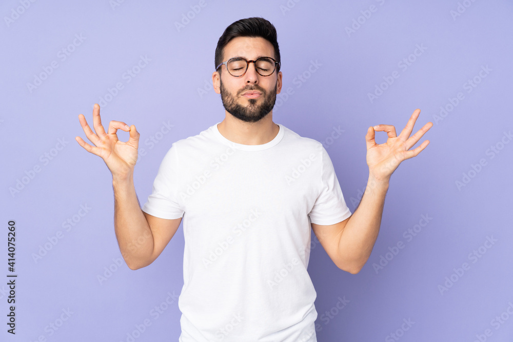 Caucasian handsome man over isolated background in zen pose Caucasian handsome man over isolated background in zen pose