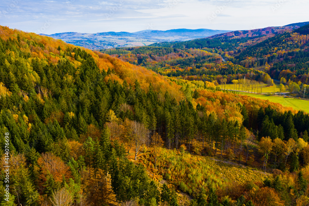 View from drone of natural landscape with autumn mixed woodlands on hillsides