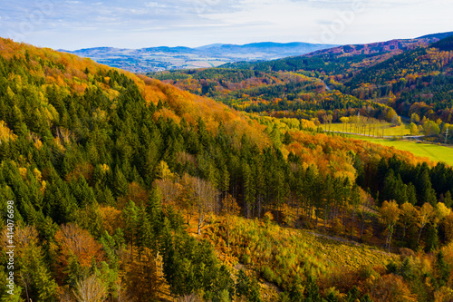 View from drone of natural landscape with autumn mixed woodlands on hillsides