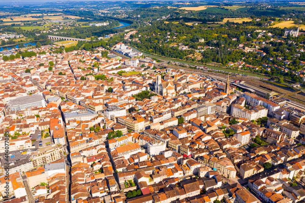 General aerial view of Agen summer cityscape on bank of Garonne river on sunny day, France