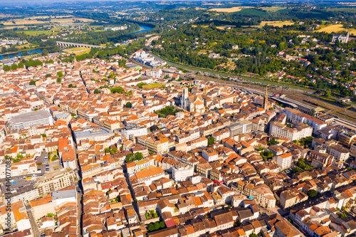 General aerial view of Agen summer cityscape on bank of Garonne river on sunny day, France